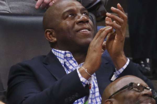 Magic Johnson, president of basketball operations for the Los Angeles Lakers, applauds as he watches the kiss cam on the scoreboard during the third quarter of an NBA basketball game between the Lakers and the Oklahoma City Thunder in Oklahoma City, Friday, Feb. 24, 2017. Oklahoma City won 110-93.