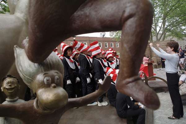 FILE - In this May 31, 2002, file photo, children from a local elementary school, dressed as the character Cat in the Hat, perform songs next to a newly installed sculpture of Dr. Seuss characters, Thing 1 and Thing 2, during a memorial dedication in author Theodore Geisel's hometown of Springfield, Mass. Tourism and economic development officials in February 2017 re-branded the western Massachusetts region known as the "Pioneer Valley," which includes Springfield and generally covers the Massachusetts portion of the Connecticut River Valley, as "West Mass."