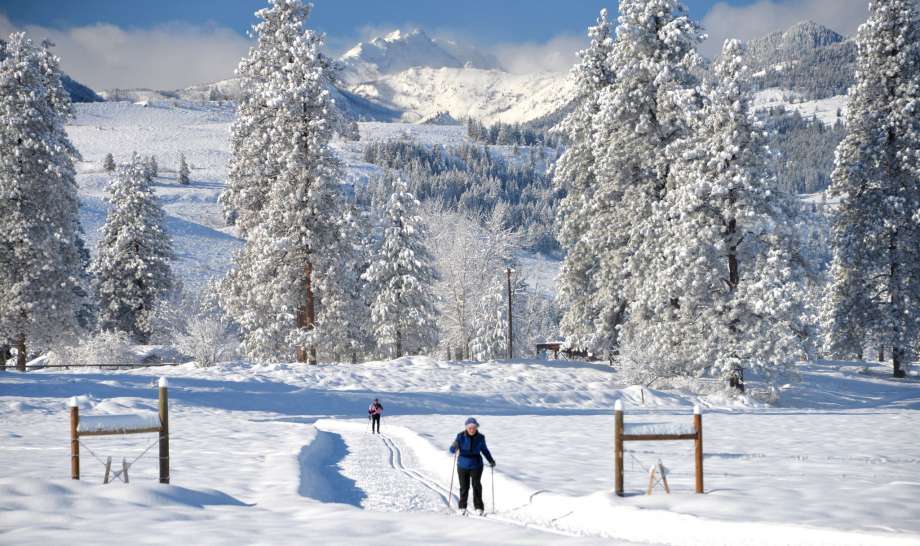 Methow Trails cross-country ski area in Winthrop Washington enjoys sunny days and light powder snow. The beauty of the trail system is the wide, open landscapes and incredible mountain scenery. Here skiers travel along the Methow Community Trail that connects the town's of Winthrop and Mazama. Photo: Photo Courtesy Of Methow Valley Photography