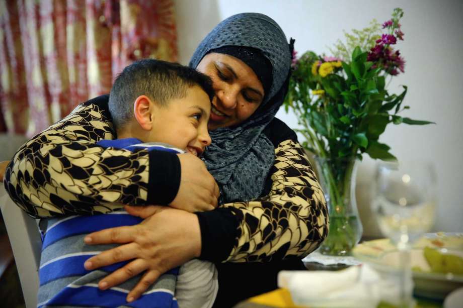 Rabah Saleh talks with her youngest son Ahmad, 7, Feb. 14, 2017. Since fleeing from Syria to the U.S. via Jordan one year ago, she has started working part time as a janitor at a local school in West Seattle. Photo: GENNA MARTIN, SEATTLEPI.COM / SEATTLEPI.COM