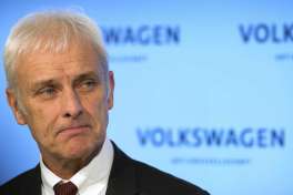 The CEO of Volkswagen Matthias Mueller gestures during a press conference held after the conclusion of the company's board of directors meeting in Wolfsburg, Germany, Friday, Feb. 24, 2017. Volkswagen bounced back into the black in 2016 after suffering a loss the previous year due to the diesel emissions scandal, according to figures released by the German automaker Friday. (Swen Pf'rtner/dpa via AP)