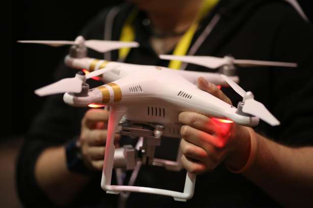 A DJI drone is held at The CES Unveiled press event, January 4, 2016 in Las Vegas, Nevada ahead of the CES 2016 Consumer Electronics Show.  CES, the annual consumer electronics and consumer technology trade show in Las Vegas boasts some 2.2 million net square feet of exhibition space.