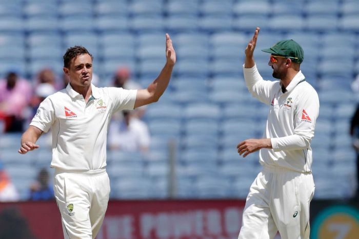 Steve O'Keefe and Nathan Lyon high five in Pune