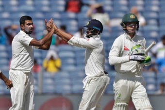 Peter Handscomb trudges off as Ravi Ashwin celebrates