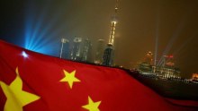 The Chinese flag flies with the Pudong skyline in the background