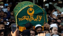 Supporters carry the coffin of Ko Ni.