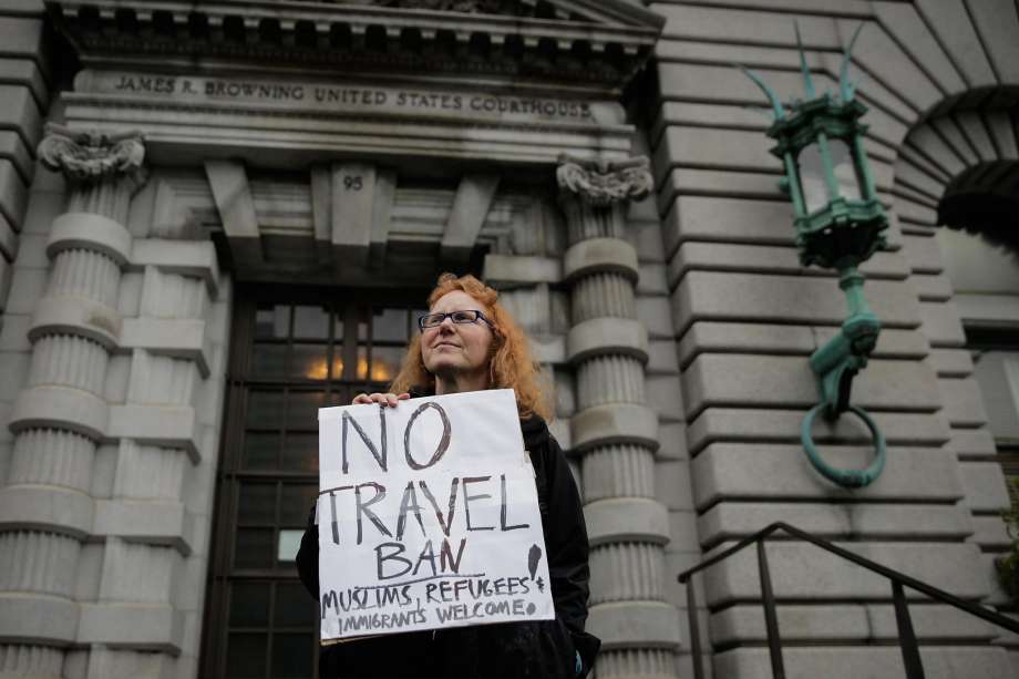 Demonstrator Beth Kohn (center) protests President Donald Trump's travel ban while standing in front of the Ninth Circuit Court of Appeals which is hearing the travel ban case today in San Francisco, California, on Tuesday, Feb. 7, 2017. Photo: Gabrielle Lurie, The Chronicle