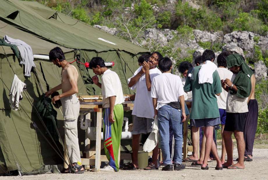 Men prepare for the day in 2001 at a refugee camp on the Island of Nauru. Photo: Rick Rycroft, Associated Press