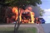 Fire engulfs a maxi taxi parked in a Brisbane street