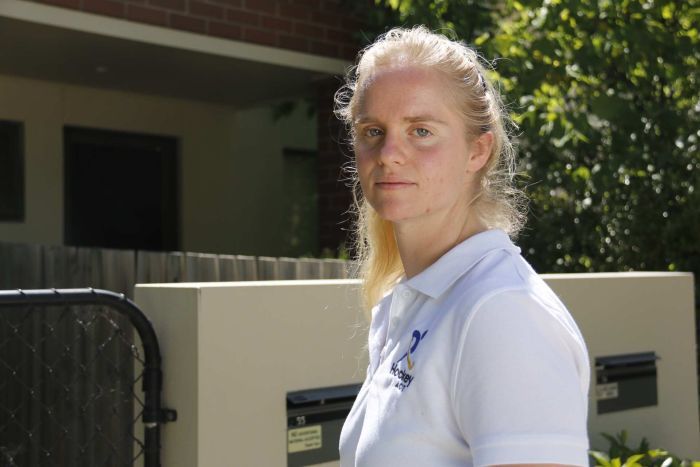 A woman stands outside a unit in Canberra.