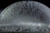 A close-up of a frozen soap bubble