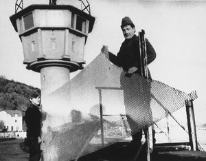 East German border guards remove a section of fence, Nov. 29, 1989 in front of a watch tower along the East-West German border at Phillipsthal, about 120 miles northeast of Frankfurt.