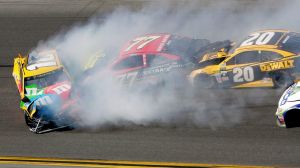 Erik Jones (77) and Matt Kenseth (20) collide with Kyle Busch (18).