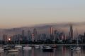 Smoke from a massive factory fire in Coolaroo hangs over the city today.