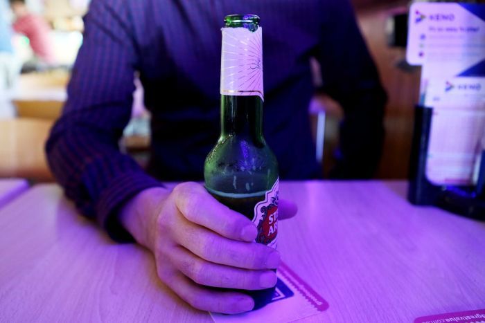 Man holding beer at pub