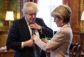 British Foreign Secretary Boris Johnson has his tie straightened by his Australian counterpart Foreign Minister Julie Bishop.