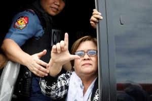 Senator Leila De Lima gestured a sign meaning 'Laban' (Fight) as she was taken away (Reuters: Erik De Castro)