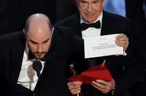 La La Land producer Jordan Horowitz (L) holds up the winner card reading actual Best Picture winner Moonlight with actor ...