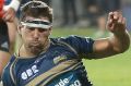 The Brumbies' Chris Alcock, right, and Crusaders' Wyatt Crockett compete for the ball.