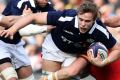 Scotland's Jonny Gray is brought to the ground.