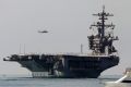 The aircraft carrier USS Carl Vinson sails out of San Diego Harbour.