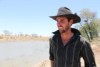 Cattle producer looks over dam