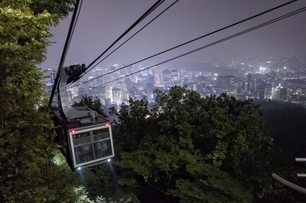 Enjoy the cityscape from the cable car to Namsan Tower.