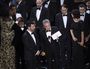 Presenter Warren Beatty shows the envelope with the actual winner for best picture as host Jimmy Kimmel, left, looks on at the Oscars on Sunday, Feb. 26, 2017, at the Dolby Theatre in Los Angeles. The winner was originally announced as La La Land, but was later corrected to Moonlight.