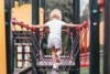 Child walking across a playground - generic