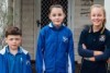 Carys Priest and her brother and sister, out the front of their home, on her first day of high school in 2017 in Kalgoorlie.