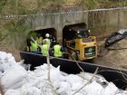 Police are collecting and sifting through mud in a Cobalt Street drain in Carole Park.