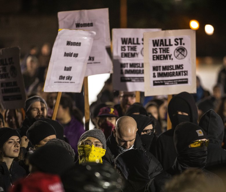 Anarchists make their presence known at the foot of Kane Hall. (Dean Rutz/The Seattle Times)