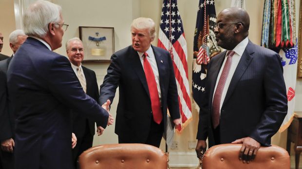 Donald Trump, greets Independence Blue Cross and Health CEO Joseph Swedish, left, and Kaiser Permanente CEO Bernard ...