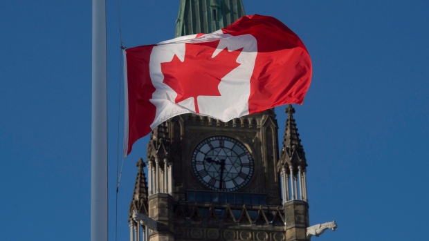 The flag flies at half-mast on a flag pole near the Peace tower on Parliament Hill Monday in memory of the victims of the Quebec City shooting. 