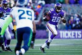 Minnesota Vikings running back Adrian Peterson runs the ball in Sunday's NFC wild card game in Minneapolis