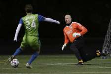 Former Seattle Sounders forward Roger Levesque, left, scores a goal on former Sounders goalkeeper Kasey Keller during the first half of the Zach Scott Testimonial Match, Wednesday, March 1, 2017, in Seattle. The match was held to honor Scott, who retired last year after 15 seasons with different incarnations of the club.