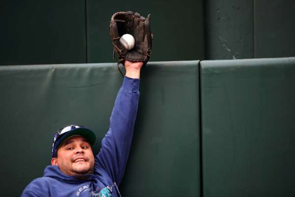 Aaron Youckton, of Yelm, pretends to make an outfield catch during Mariners FanFest at Safeco Field, Saturday, Jan. 28, 2017.