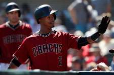 Jean Segura of the Arizona Diamondbacks high-fives teammates in the dugout after hitting a solo home run against the Oakland Athletics during the first inning of the spring training game at Salt River Fields at Talking Stick on March 4, 2016 in Scottsdale, Arizona.  (Photo by Christian Petersen/Getty Images)