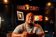 Two-time Super Bowl champ Casey Hampton, who played for the Pittsburgh Steelers, 
enjoys card games and dominoes in his man cave. Though spare on sports  memorabilia, his décor includes an ESPN cover featuring his team, right.