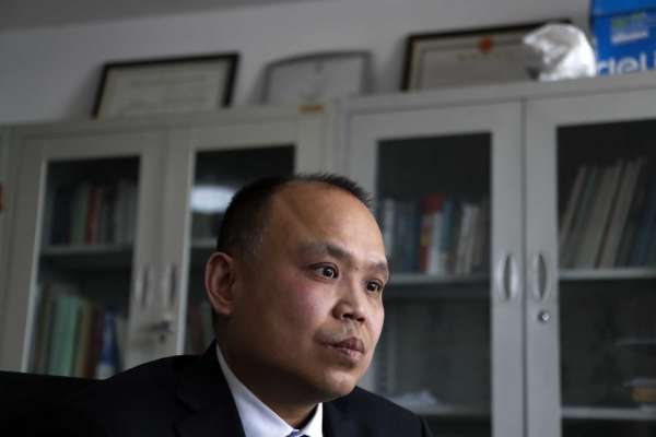 In this Feb. 24, 2017 photo, Chinese lawyer Yu Wensheng pauses during an interview at his office in Beijing. A group of Chinese lawyers is suing the governments of Beijing and its surrounding areas for not doing enough to get rid of the smog. They are asking for compensation and for the authorities to apologize for adversely affecting their lives.