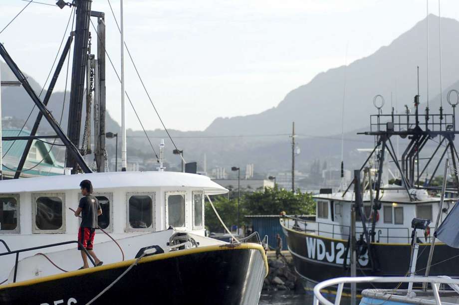 FILE - In this Thursday, Feb. 2, 2017 file photo, a man works on a commercial fishing boats docked at Pier 38 in Honolulu. The sponsor of a Hawaii bill seeking to change the way commercial licenses are granted to foreign fishermen says the bill is in danger of dying after fishing industry representatives told lawmakers the bill could wreck the industry. The bill would restrict commercial fishing licenses to people who are legally allowed to enter the U.S. Photo: Caleb Jones, AP / Copyright 2017 The Associated Press. All rights reserved. This material may not be published, broadcast, rewritten or redistribu