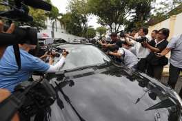 Media film and photograph a North Korean diplomatic vehicle leaving the North Korean embassy in Kuala Lumpur, Malaysia, Thursday, March 2, 2017. Malaysia is scrapping visa-free entry for North Koreans traveling into the country, the state news agency said Thursday in the latest fallout from a deadly nerve agent attack at Kuala Lumpur airport.