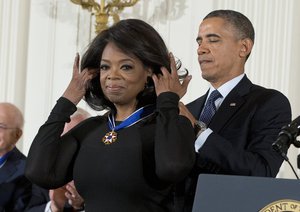 President Barack Obama awards Oprah Winfrey with the Presidential Medal of Freedom, Wednesday, Nov. 20, 2013, during a ceremony in the East Room of the White House in Washington