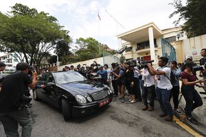 Members of the media filming while a North Korean diplomatic vehicle leaving the North Korean embassy in Kuala Lumpur, Malaysia, Thursday, March 2, 2017. Malaysia is scrapping visa-free entry for North Koreans traveling into the country, the state news agency said Thursday in the latest fallout from a deadly nerve agent attack at Kuala Lumpur airport. (AP Photo/Vincent Thian)