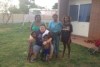 A group of people smiling in a backyard