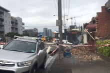 Emergency crews pull a bus out of a North Melbourne cafe