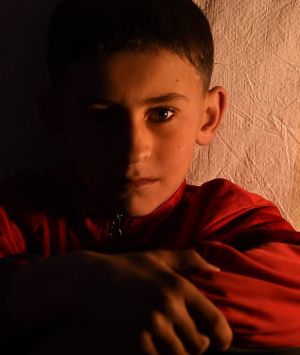 Hussein Hatem 10 sits inside his families tent at Khazer Camp 1 home to 38,000 internall displaced Iraqi's who have fled ...