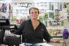 a woman standing behind a store counter