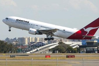 Qantas profits dive