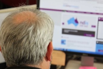 Man looks at the NDIS website